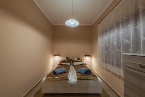 a bedroom with a bed and a large painting on the wall at Hege Vendégház in Bükkmogyorósd