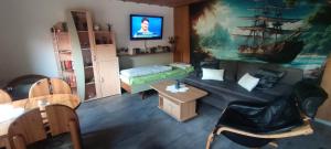 a living room with a couch and a table at Sonnenhaus Leo Hutthurm in Hutthurm +13 photos
