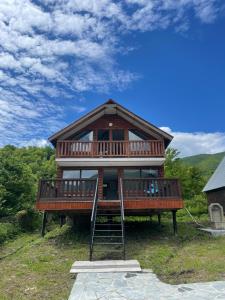 a large house on a hill with a ladder at Racha Hills in Ambrolauri