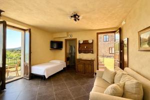 a living room with a couch and a bed at Antico Borgo Petralia in Zafferana Etnea