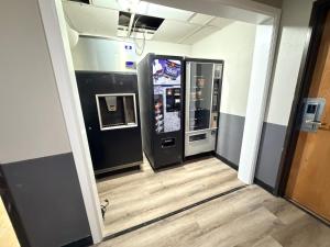 a hallway with two vending machines in a building at Super 8 by Wyndham Macomb in Macomb