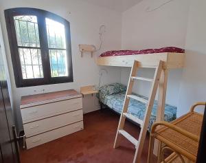 a bedroom with a bunk bed and a desk and a ladder at Casa Sofia in Torre delle Stelle