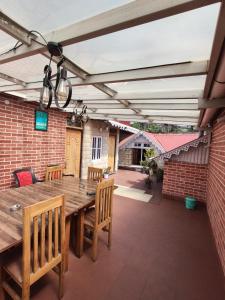 an outdoor patio with a wooden table and chairs at Nizel Inn in Darjeeling