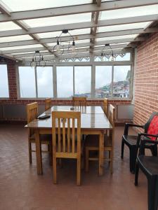 a dining room with a wooden table and chairs at Nizel Inn in Darjeeling +33 photos