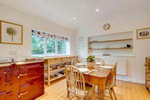 a kitchen with a wooden table and chairs in a room at 2 Bed in Matlock oc-dcocc in Two Dales +8 photos