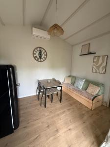 a living room with a couch and a table at Charmant chalet près d Albi et des vignobles in Rivières
