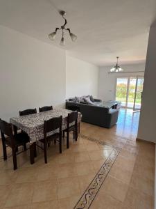 a living room with a table and a couch at Saidia Marina in Saïdia