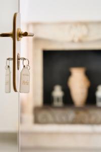 a door latch with a tag in front of a fireplace at B&B Soldano in Peschici +90 photos