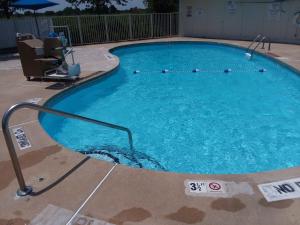 a large swimming pool with blue water in a building at Knights Inn Burlington NC in Burlington