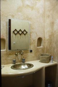 a bathroom with a sink and a mirror on a counter at Riad Azula in Salé