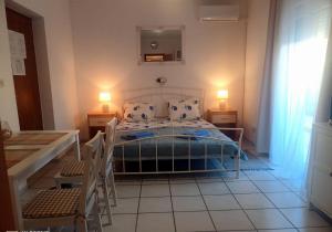 a bedroom with a bed with two lamps and two chairs at Villa Abelia in Medulin