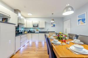 a kitchen and dining room with a long wooden table at 2 Bed in Torcross oc-bcatbe in Torcross