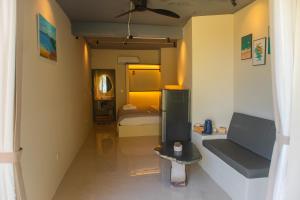 a room with a bedroom with a bed and a couch at Chill Beach House in Phú Quốc
