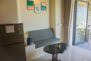 a room with a table and a refrigerator and a table at Chill Beach House in Phú Quốc
