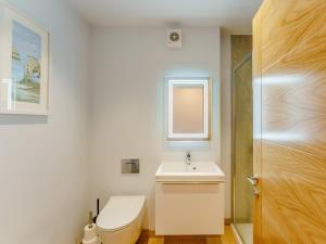 a white bathroom with a toilet and a sink at 2 Bed in Brockenhurst oc-78729 in Brockenhurst