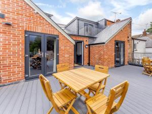 a wooden table and two chairs on a deck at 2 Bed in Brockenhurst oc-78729 in Brockenhurst