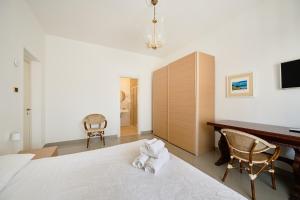 a bedroom with a bed and a desk and chairs at B&B Soldano in Peschici