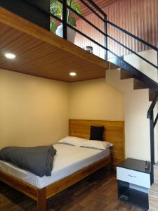 a bedroom with a bed and a staircase at Nizel Inn in Darjeeling