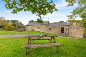 a picnic table in front of a stone house at 3 Bed in Bishop Auckland oc-36671 in Wolsingham