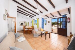 a living room with a couch and a table at Villa Ca Nostra in Cala en Porter