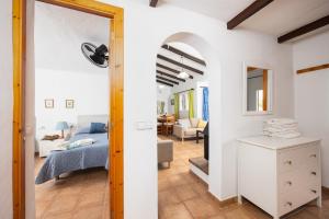 a room with a bed and a living room at Villa Ca Nostra in Cala en Porter +20 photos