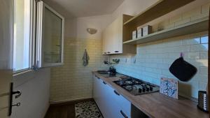 a kitchen with a sink and a stove in it at Residenza Tulipano in Eraclea Mare
