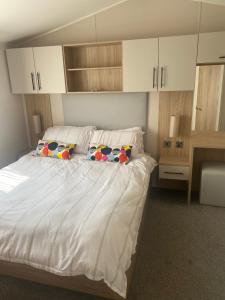 a bedroom with a bed with two pillows on it at Aqua bay whistable in Swalecliffe +17 photos