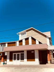 a building on a street with a blue sky at Гостьовий Дім Guest House in Kotowsk