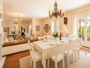 a dining room with a white table and chairs at Villa Golden Tiara Large Private Pool AC WiFi in Corfu