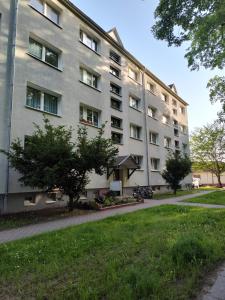 a large apartment building with a lawn in front of it at Monteurwohnungen Bad Langensalza in Bad Langensalza