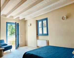 a bedroom with a bed and a chair and a window at Villa Gioia Agriturismo in Monterosso al Mare