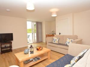 a living room with a couch and a table at 1 Bed in Kelso oc-52538 in Morebattle