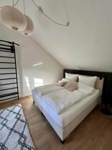 a bedroom with a large white bed with white pillows at Halleluja mit Burgblick in Hellenthal