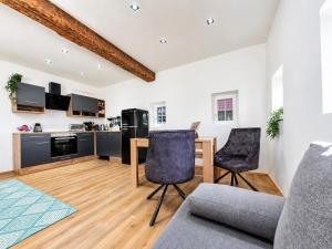 a kitchen and living room with a table and chairs at Chalet Rebenruhe Südsteiermark in Praratheregg +28 photos