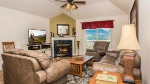 a living room with couches and a fireplace at WP651 Smokin' Views Penthouse in Pigeon Forge
