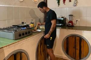 a man standing in a kitchen preparing food at Hostal Mulut Tulum in Tulum +43 photos