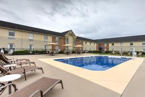 a pool at a hotel with benches and tables at Comfort Inn Lancaster at Rockvale in Lancaster