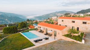 an aerial view of a house with a swimming pool at Canhoto Douro in Marco de Canaveses