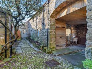 an entrance to a stone building with an archway at 2 Bed in Settle oc-g0051 in Settle