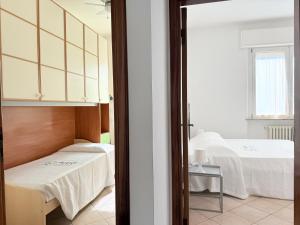 a bedroom with two beds in a room at SE238 - Marotta, quadrilocale con corte privata in Marotta