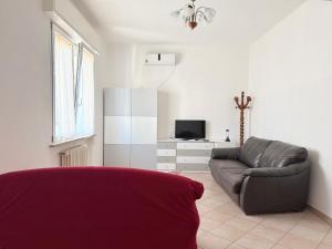 a living room with a couch and a tv at SE238 - Marotta, quadrilocale con corte privata in Marotta