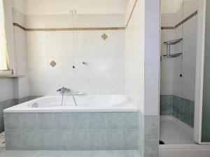 a bathroom with a bath tub and a shower at SE238 - Marotta, quadrilocale con corte privata in Marotta +16 photos