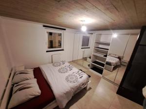 a small bedroom with a bed and a mirror at Chambres d'hotes in Bertrix