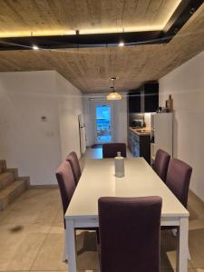 a kitchen and dining room with a table and chairs at Chambres d'hotes in Bertrix