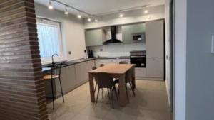 a kitchen with a wooden table and a dining room at Suite del Colonnello B&b in Rionero in Vulture +1 photo