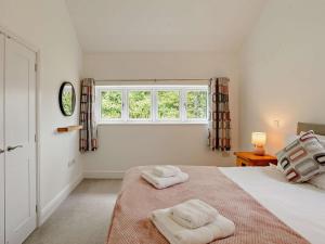 a bedroom with a bed with two towels on it at 4 Bed in Chard oc-83501 in Combe Saint Nicholas
