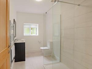 a bathroom with a toilet and a glass shower at 4 Bed in Chard oc-83501 in Combe Saint Nicholas +19 photos