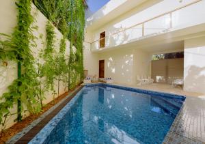 a swimming pool in a house with a building at Cavendish Polhena in Matara