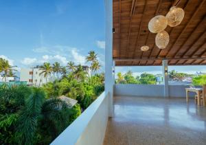 a balcony of a house with a view of palm trees at Cavendish Polhena in Matara