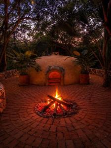a fire pit in the middle of a brick courtyard at Casa Sal by Tasman in Puerto Escondido